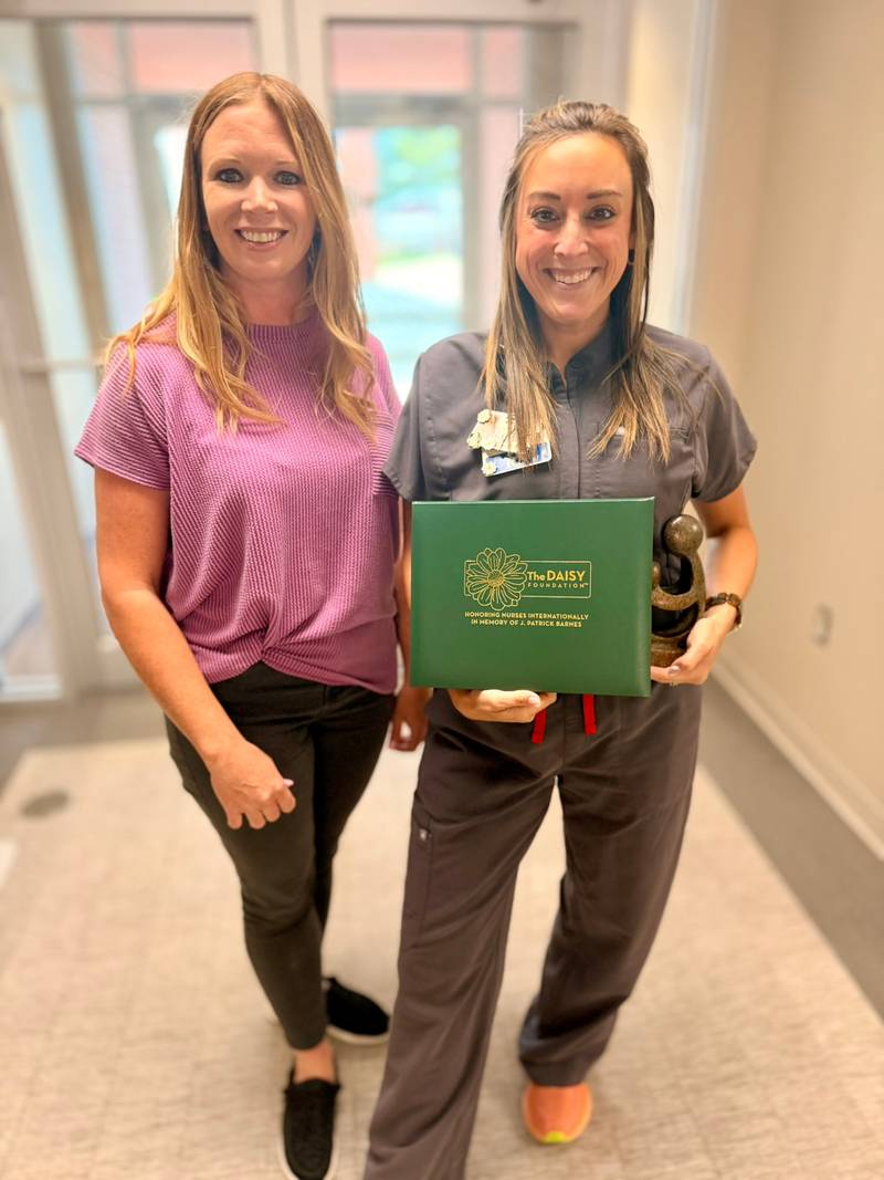 Adair County Health System's surgery manager Emily Kuhns (right) accepts the DAISY award for this year from Chief Nursing Officer Philicia Hancock.