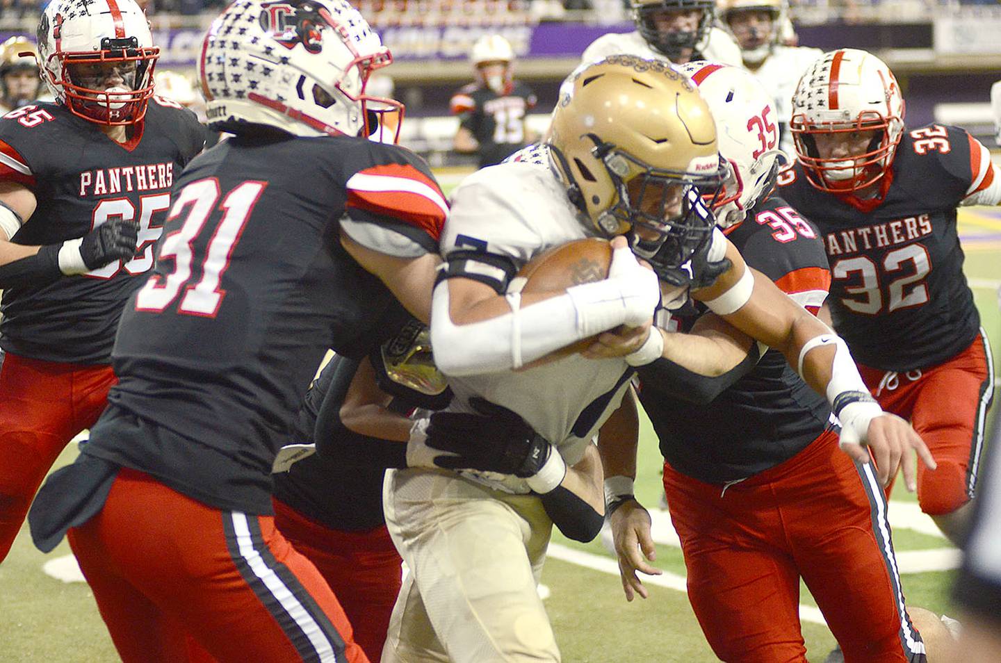 Creston's Dylan Calvin (31) and Will Bolinger (35) stop Bishop Heelan ball carrier Kasen Thomas as Austin Evans (32) closes in on the play. Boinger had a team-high nine tackles for the Panthers and Calvin had his sixth interception of the season on Saturday.