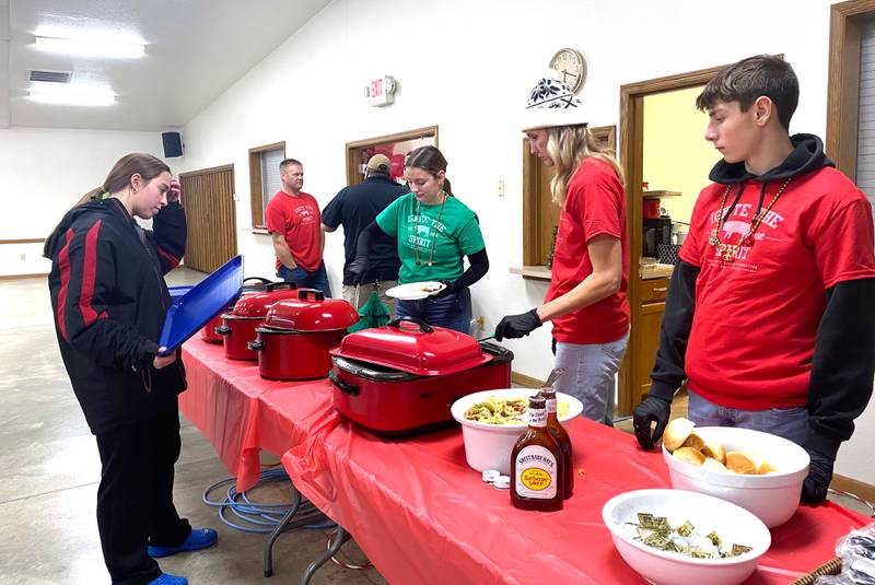 Volunteers serve food at the Ignite the Spirit Community Meal held Wednesday, Dec. 11 at the 4-H/FFA Center at the Adair County Fairgrounds.