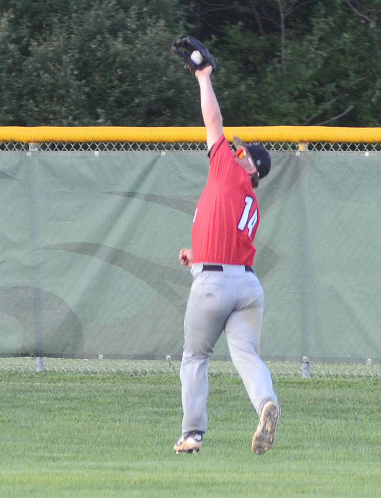 Creston's Tom Mikkelsen reaches to catch a flyball in the right-center field gap in the second inning of Wednesday's game at Saydel. Mikkelsen also pitched 1 2/3 innings and scored two runs on two hits in the game.
