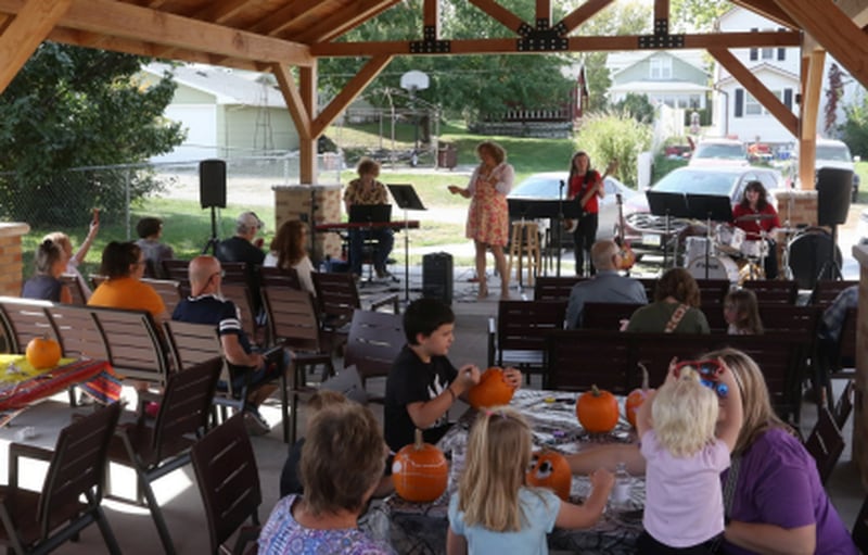 The new pavilion and outdoor furniture are utilized at the pavilion's grand opening last August.