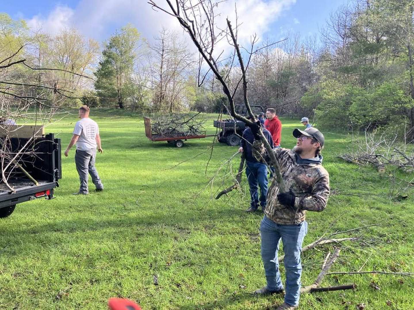 SWCC auto students work to cleanup Barbara Bills' yard during Pay It Forward week.