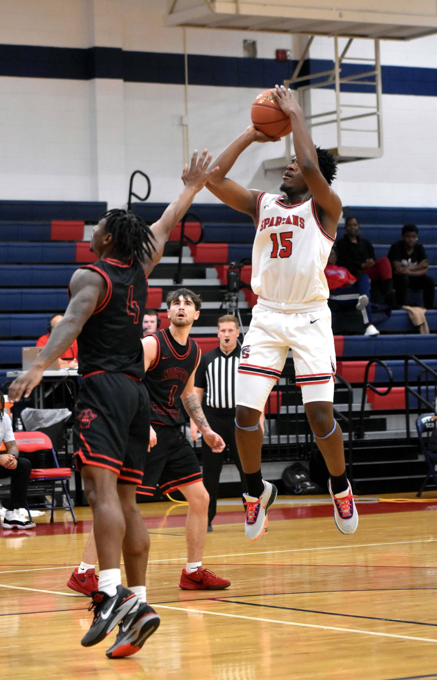 AJ Doctor puts up a contested mid-range shot. Doctor led scoring for the Spartans with 16 and had seven rebounds and three assists.