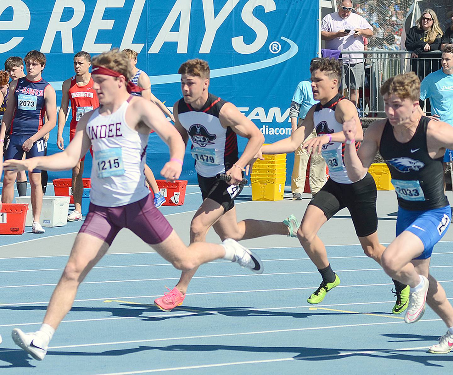 Mount Ayr 4x100 anchor runner Preston Fleharty takes the baton from teammate Trevin Victor (center) during the Drake Relays preliminary races Saturday morning. Garrett Walter and Jackson Ruggles were also on the Raider unit that placed 89th in 45.40.