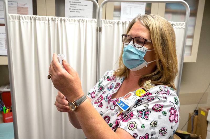 Adair County Public Health nurse Lisa Hamilton readies a flu shot for a patient.