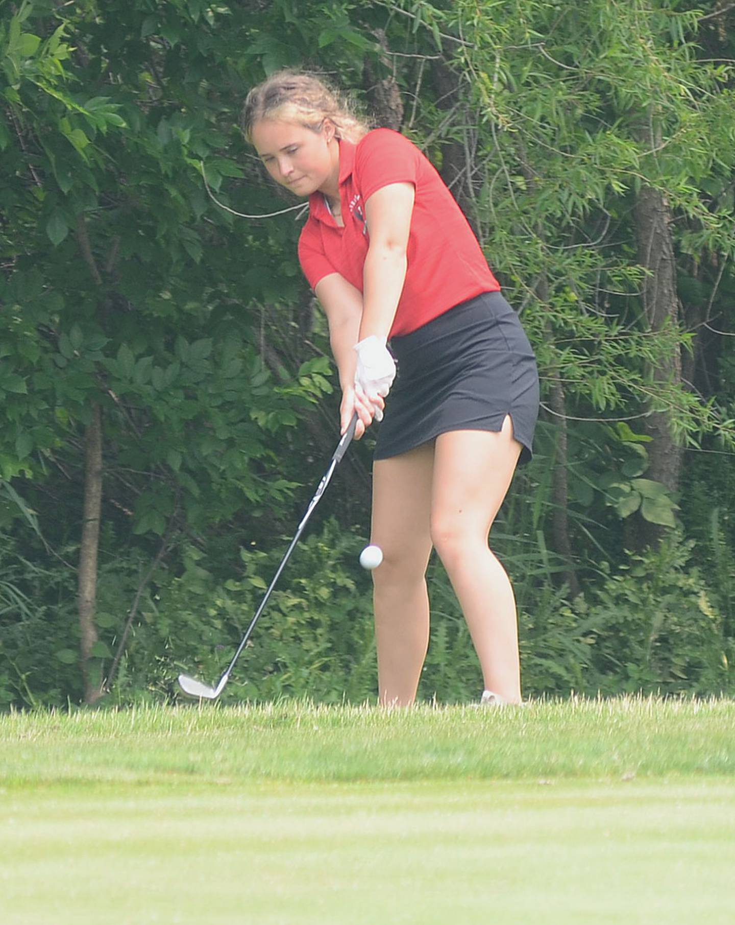 Abby Larson of Mount Ayr chips onto the ninth green at American Legion Golf Course in Marshalltown during the state tournament Friday.