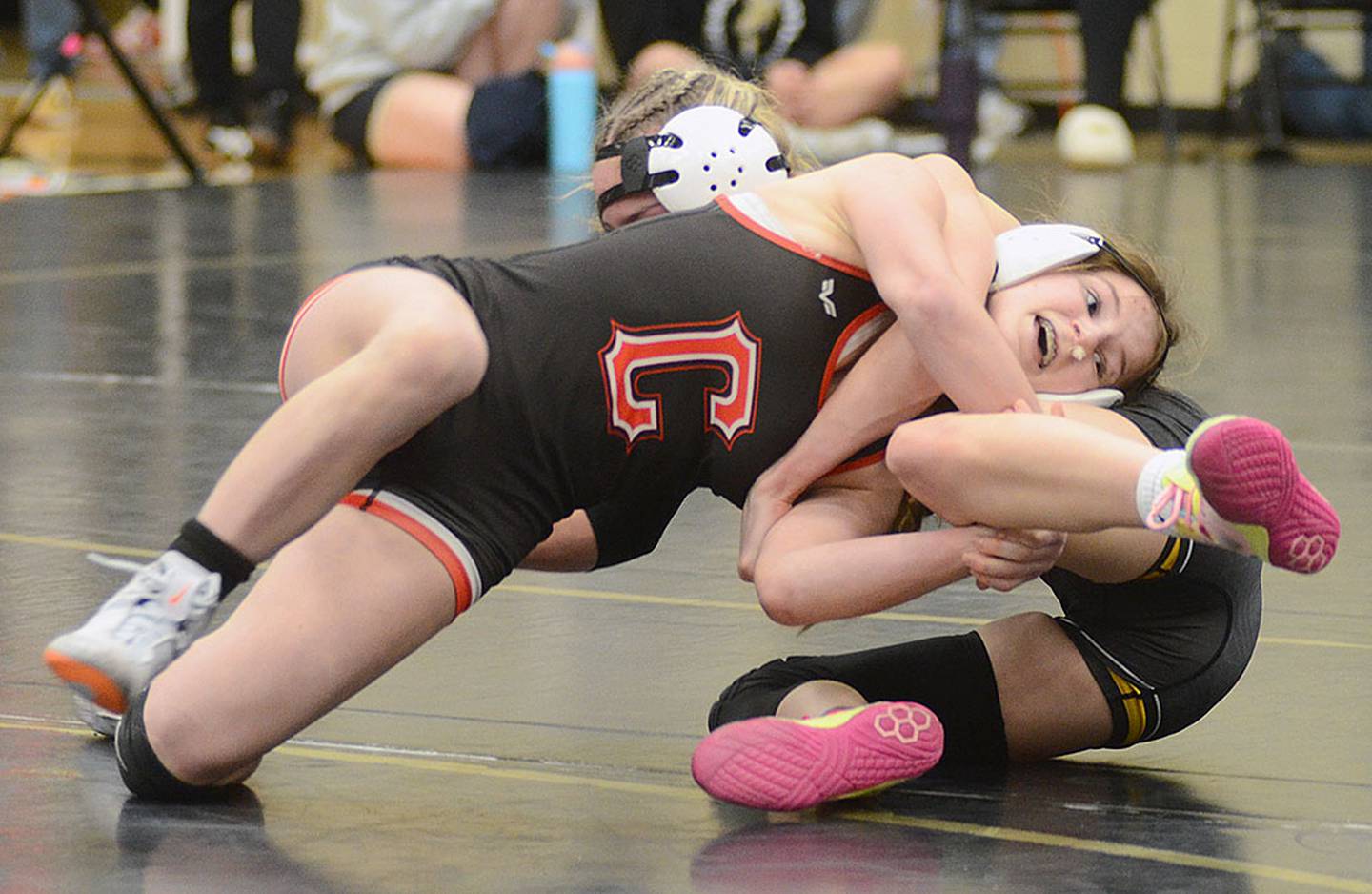 Eva Chesnut of Creston works to complete a takedown against Ainsley McLaren of Winterset. Chesnut won the consolation semifinal match, 11-10, on her way to placing fourth at 100 pounds.