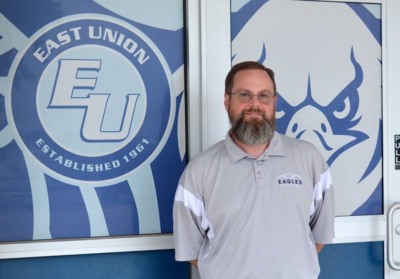 Jason Riley stands outside the entrance to the middle/high school where he will take the role of interim principal for the 2024-25 school year.