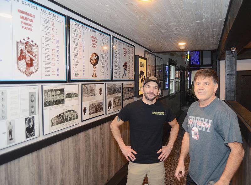 Owner Mario Galanakis (left) and local sports historian John Walters (right) stand by the Creston football display at Mario's new location, 705 S. Cherry Street.
