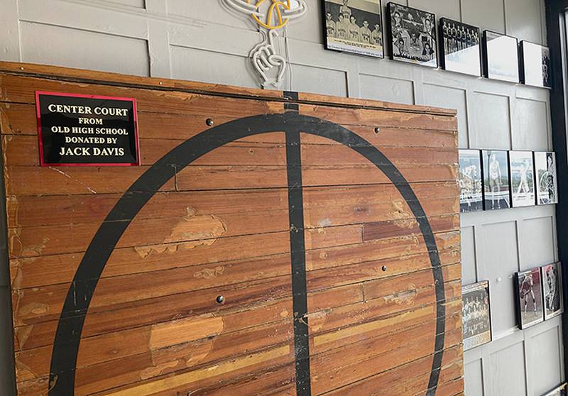 The Panther Pit center circle from the former high school, donated by Jack Davis, is the focal point of the basketball display at Anson's Bar and Grill.
