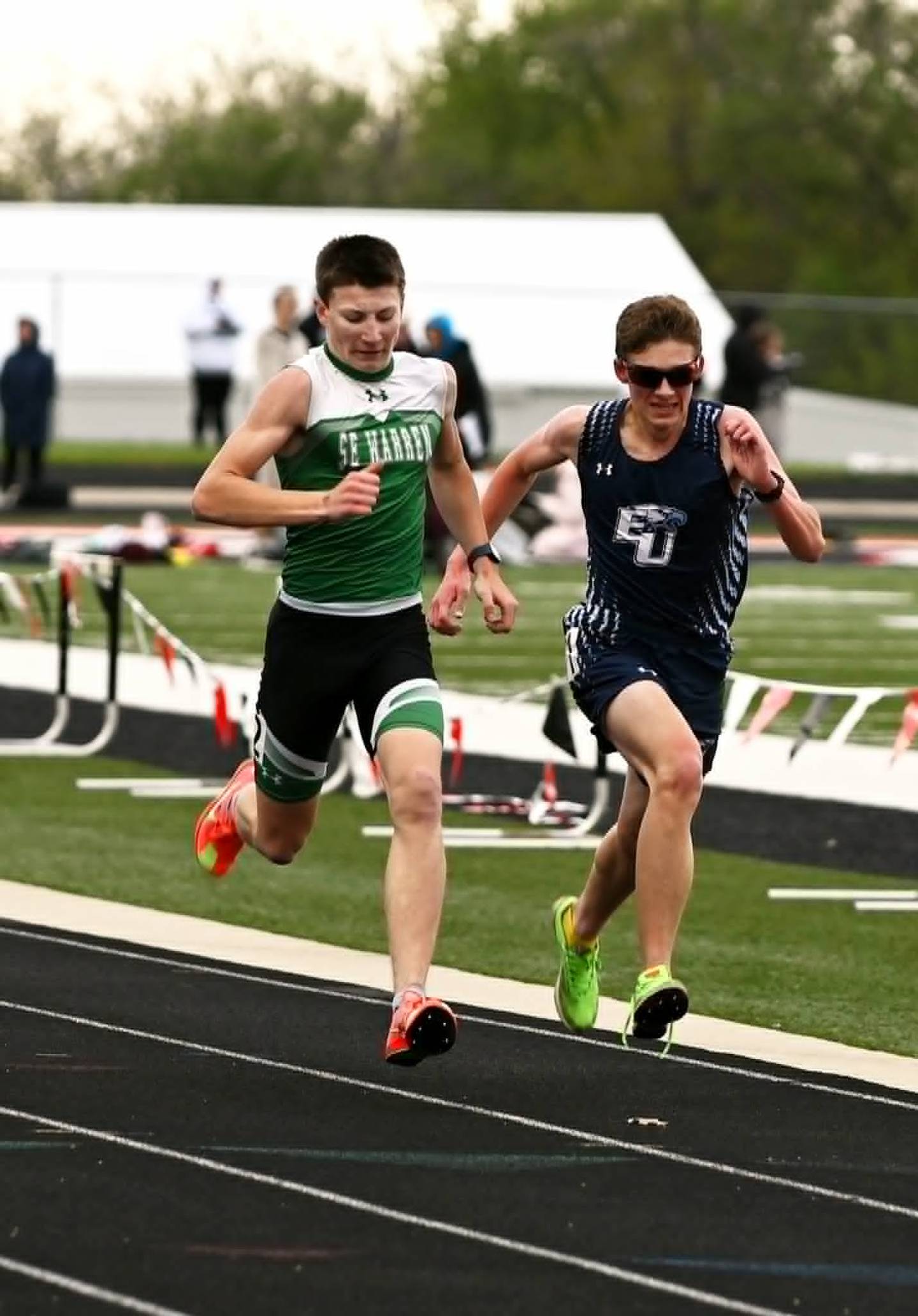 Raiden Jimenez of Southeast Warren and Brock Driskill of East Union battle down the home stretch of the 3200m run. Jimenez crossed the line 0.05 seconds ahead of Driskill for the win.