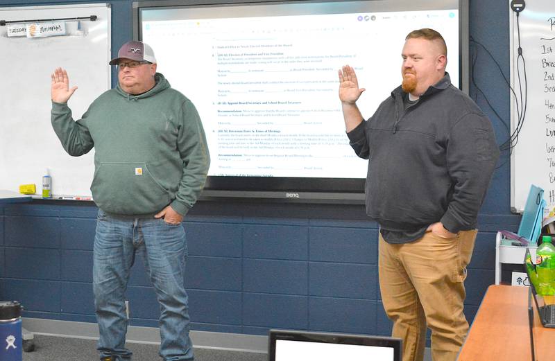 Jamie Buffington, left, and Dennis Cheers are sworn in as board members for East Union's school board.