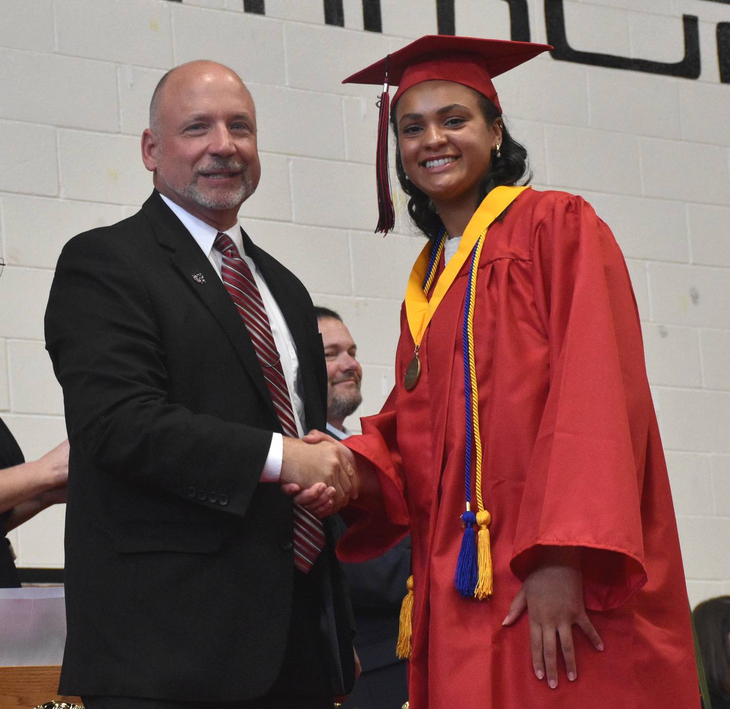 Valedictorian Khouri Sherrod is presented her honors medal by CCSD Superintendent Deron Stender.
