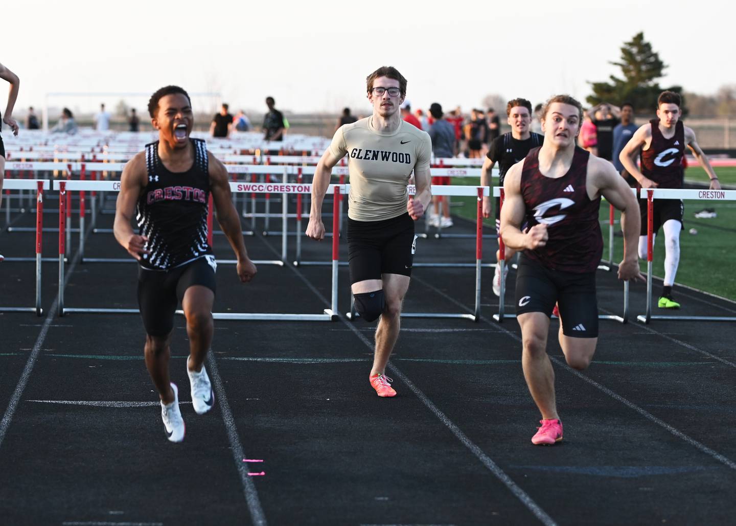 Durrell Haynes, left, lets out a yell as he runs the last portion of the 110m high hurdles Monday. Haynes won the race in 16.01. Clarke’s Urijah Fry, right, placed second in 16.11 and Glenwood’s Aaden Lopez took third in 16.55.