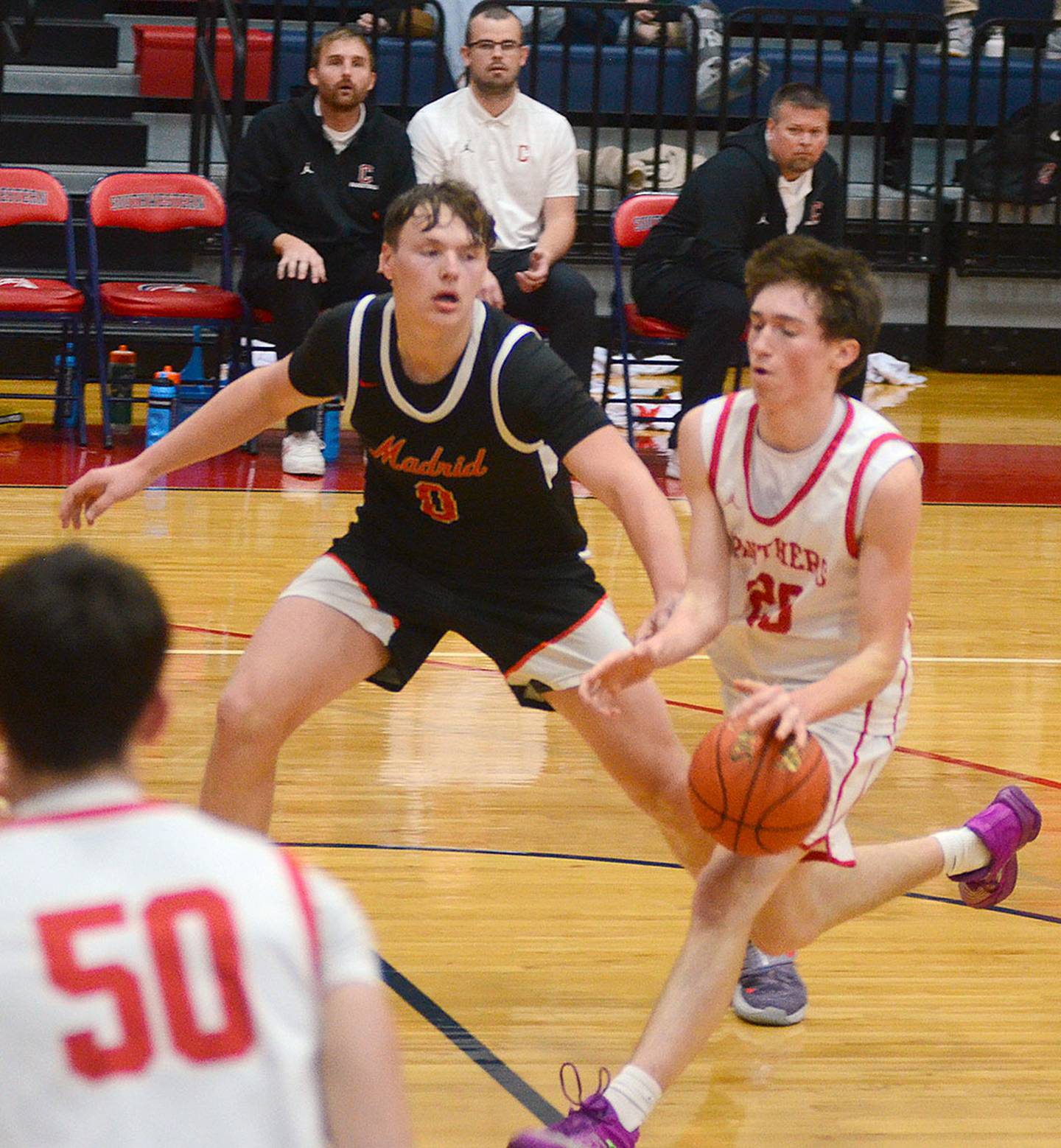 Jaxson Jondle of Creston drives in the lane against Madrid's Jevyn Severson.