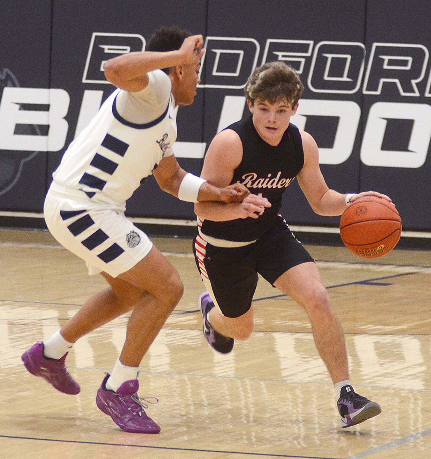 Hayes Stogdill of Mount Ayr advances the ball against Bedford's Quentin Dalton during Thursday's game. Stogdill scored a team-high 14 points in the game.