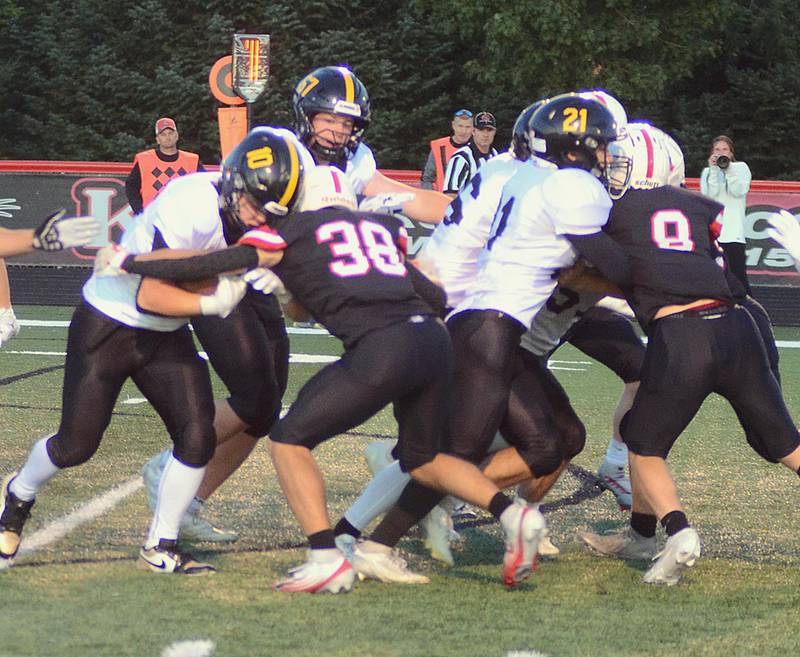 Creston safety Lane Travis (38) moves in for the tackle against Winterset running back Ben Porter (10) as linebacker Brodrick Phelps (9) battles a Winterset blocker (right).