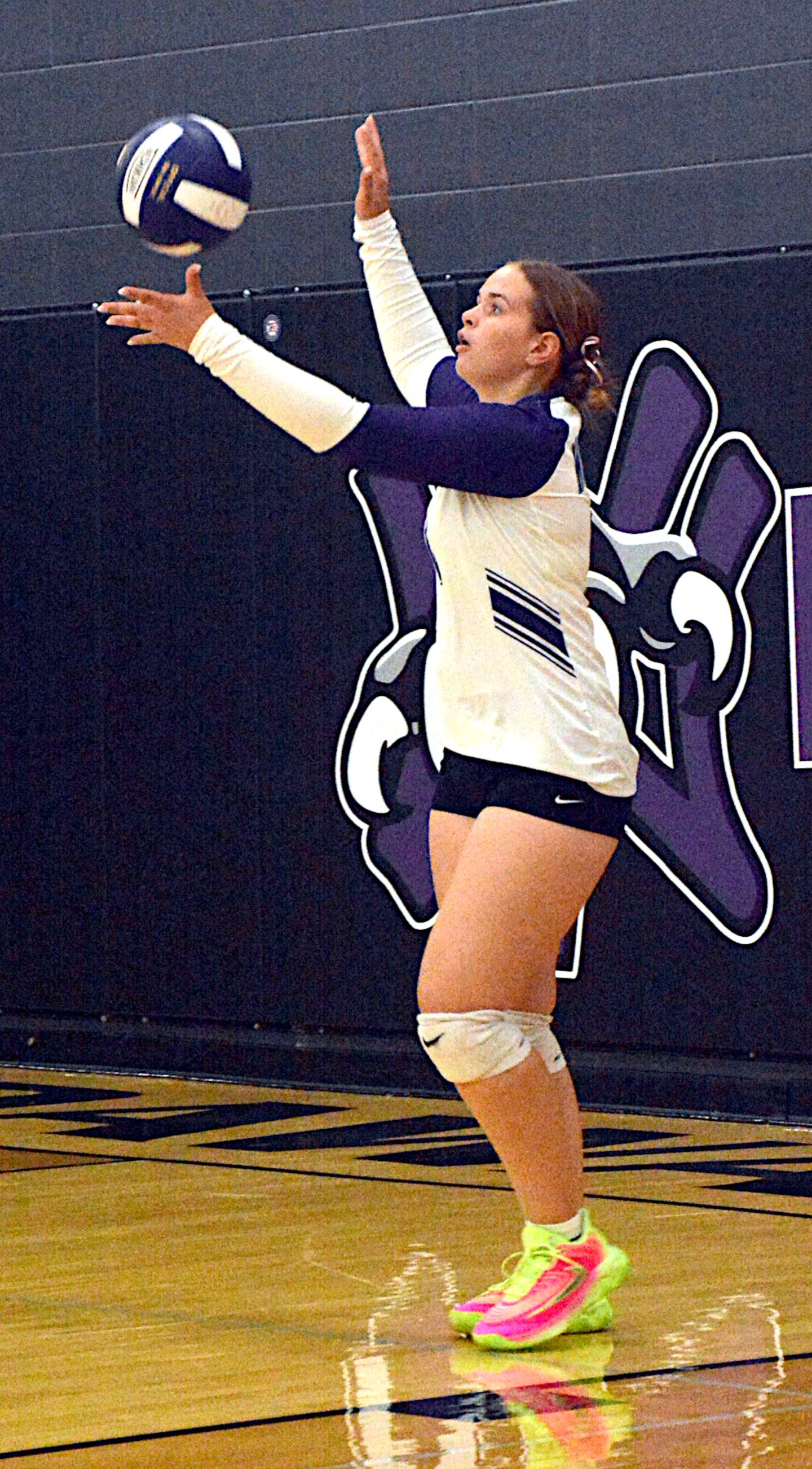 Senior Kiara Stevens concentrates on one of her serves in last Thursday's match against Lenox, where she had two consecutive first-set aces that helped her team.