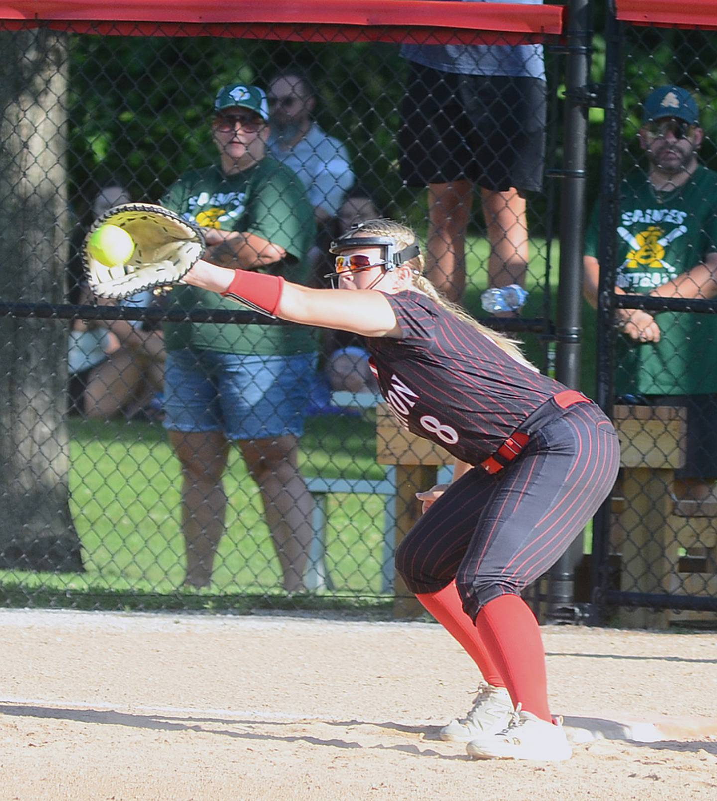 Creston first baseman Jaycee Hanson receives a throw from shortstop Mila Kuhns for a ground ball out against St. Albert Monday.