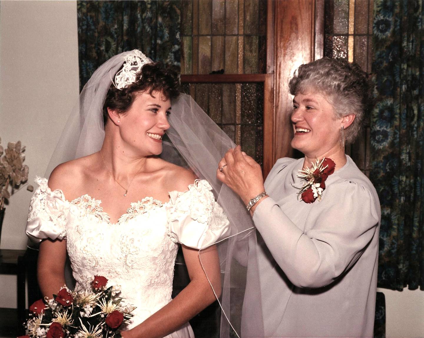 Schultz helps Barker with her wedding vail at Barker's wedding in 1986.