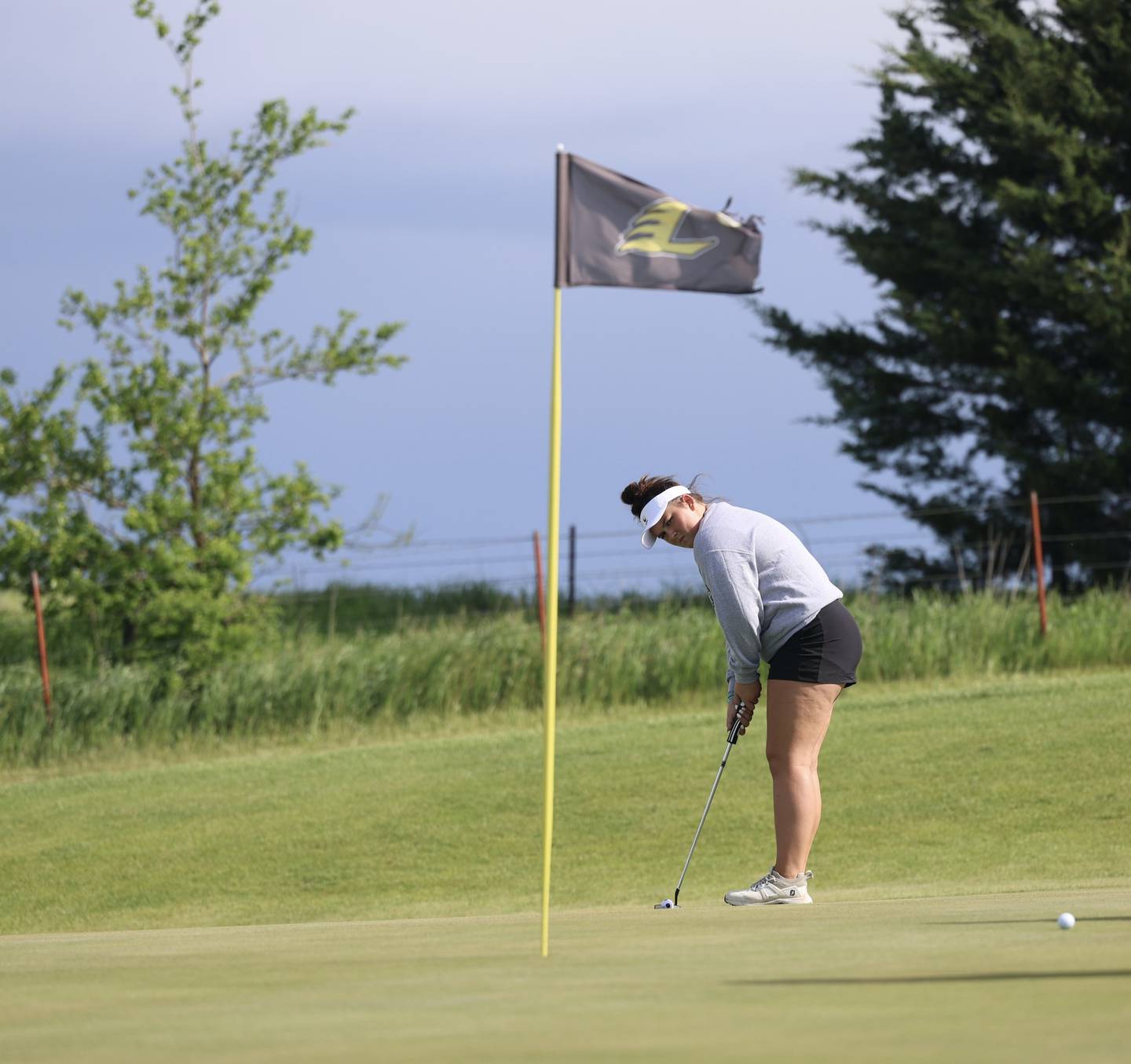 Mount Ayr senior Alana Doolittle watches a putt May 16 at Lenox in the first round of regionals golf. The Raiderettes won in Lenox and Wednesday in Crestwood to advance to the state golf tournament. Sophomore Jaylee Shaffer also qualified as an individual.