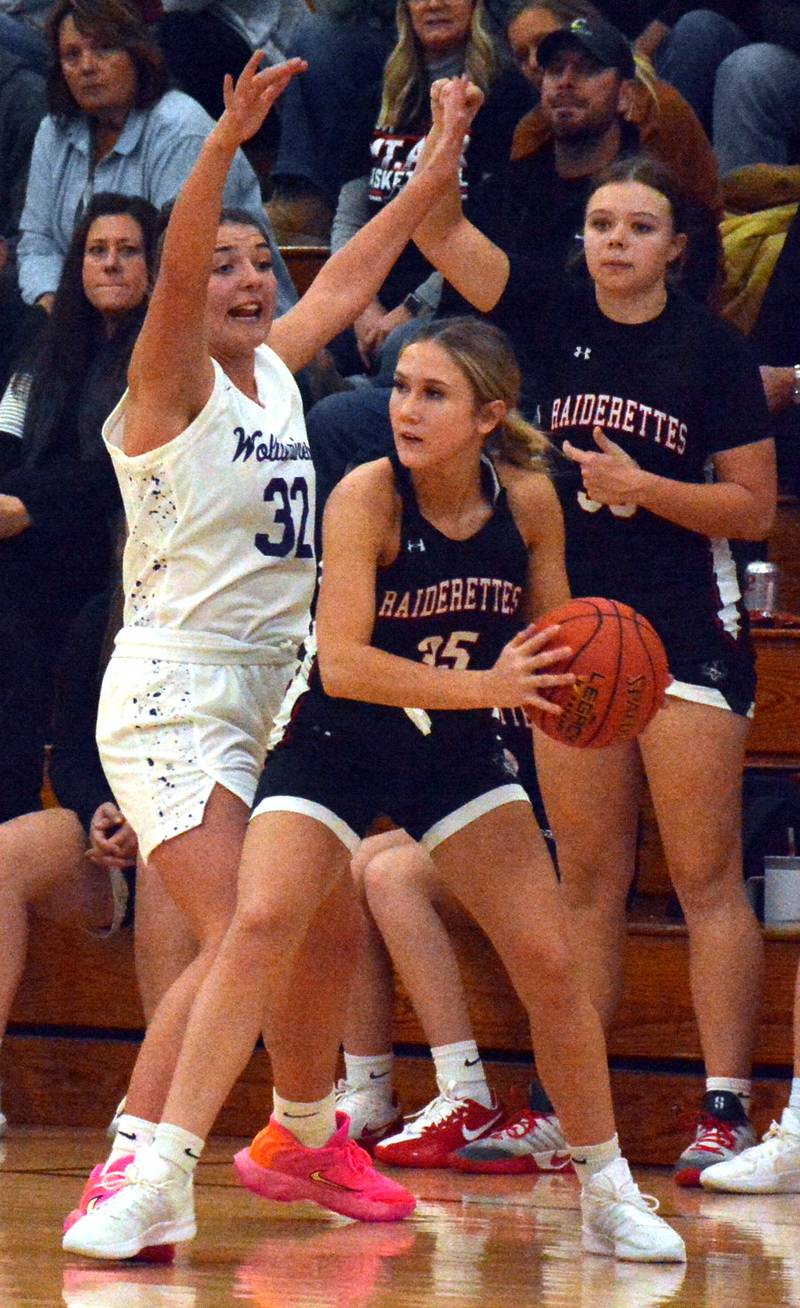 Wolverine senior Emma Boswell (32) defends Mount Ayr's Tatum Friedrich (35) last Tuesday.