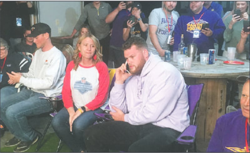 Spencer Brown takes a call from the Buffalo Bills general manager, offensive line coach and team owner just before the team selected him as the 93rd pick in the 2021 NFL Draft Friday night.