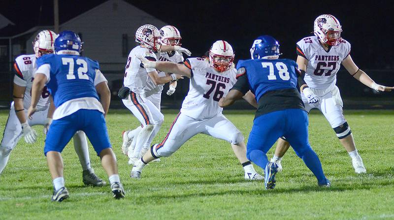 Creston quarterback Tanner Ray fakes a handoff to running back Gabe Kaufman as offensive linemen set up for pass protection. Shown from left are Layne Sand (68), Gunner Martwick (76) and Chasse Downing (67). The Panthers had 630 yards in total offense in the 54-13 win at Perry.