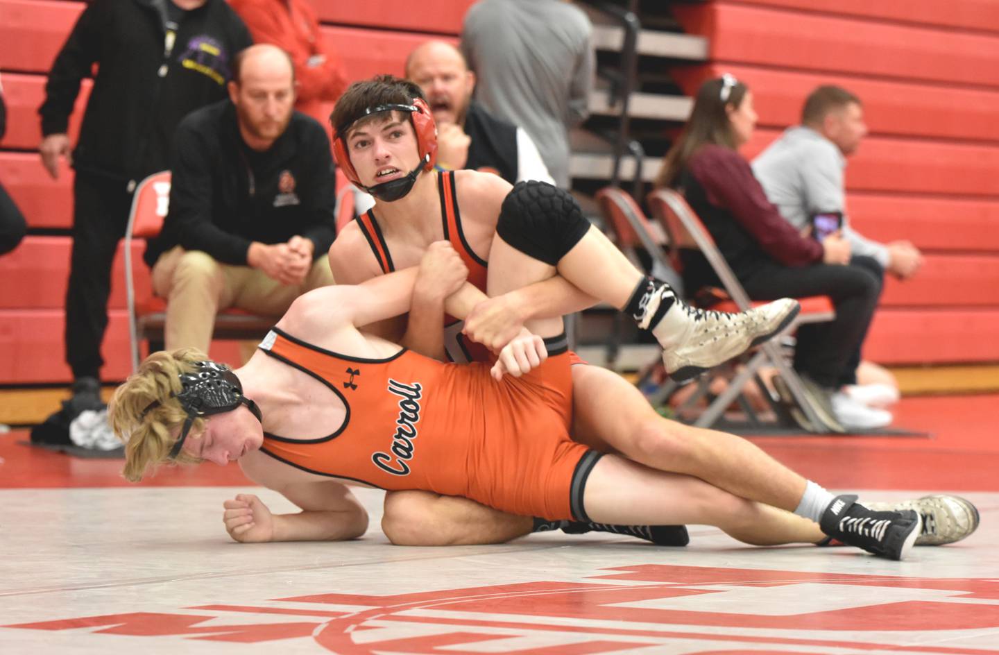 Lane Travis (113) works a tilt on Carson Tedrow of Carroll in the fifth-place match. Travis won the bout in a 10-0 major decision.