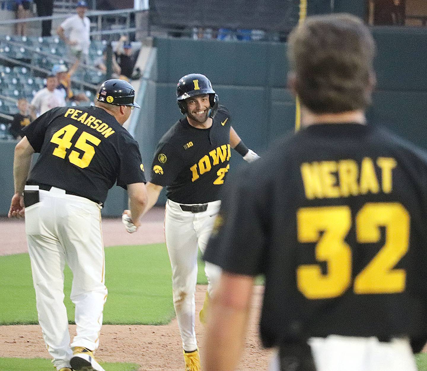 Iowa third base coach David Pearson greets Jaixen Frost after Frost's home run in Friday's 14-5 victory. It was Frost's fifth homer of the season.