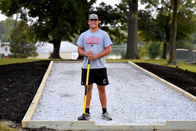 Creston senior Quinten Fuller stands with his partially-constructed Eagle Scout Service Project, a bocce ball court at McKinley Park.