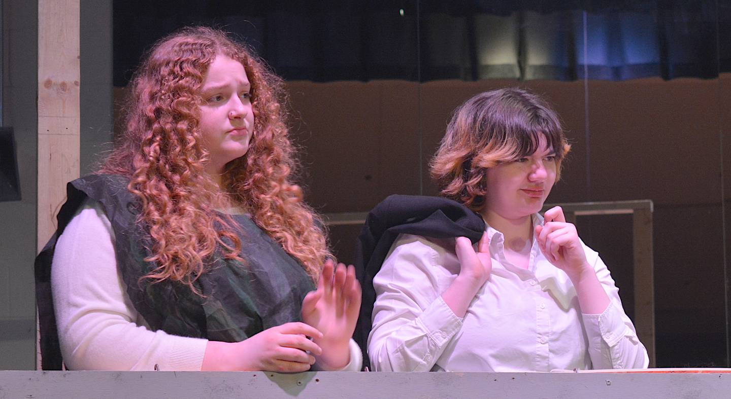 Lydia Preston, left, and Summer Prentice, right, look upon a scene during a performance.
