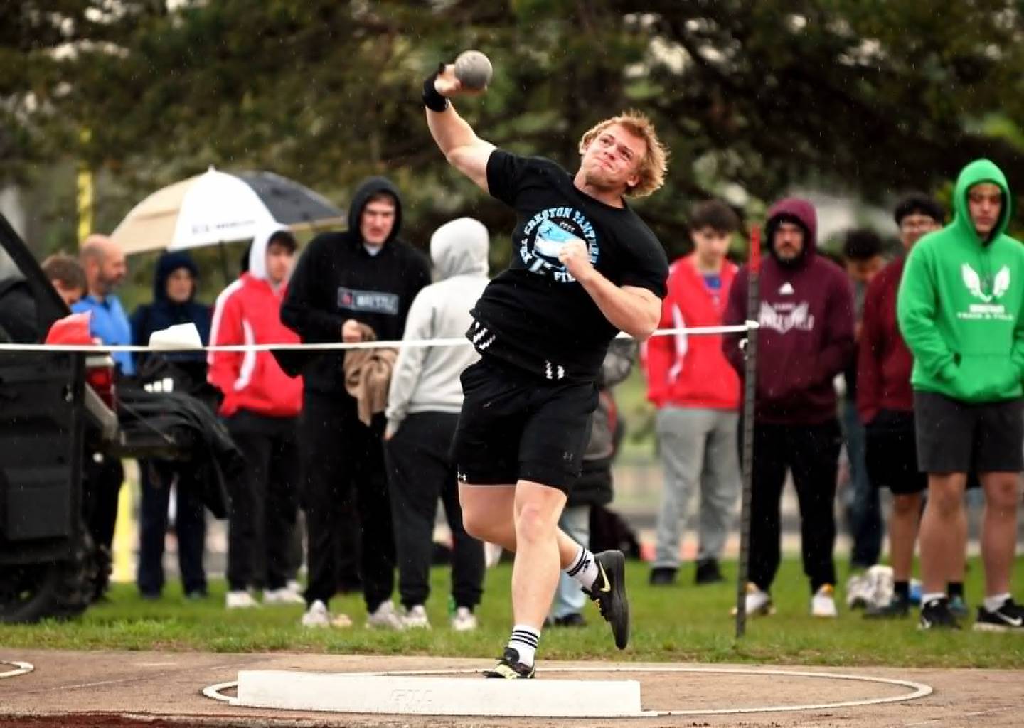Tom Mikkelsen of Creston throws the shot put for a mark of 54-04, the runner-up distance. Mikkelsen won the discus.