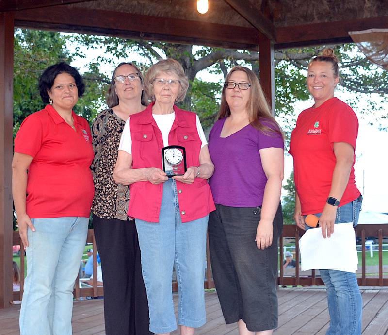 Lois Houghtaling (middle) receives Adair County's Iowa 4-H Hall of Fame nomination at the Adair County Fair for her and her husband Bob. The award was presented by Adair County Extension's Terri Raasch and Caroline Savage. Mary and Deb — two of Lois and Bob's daughters — joined her in receiving it.
