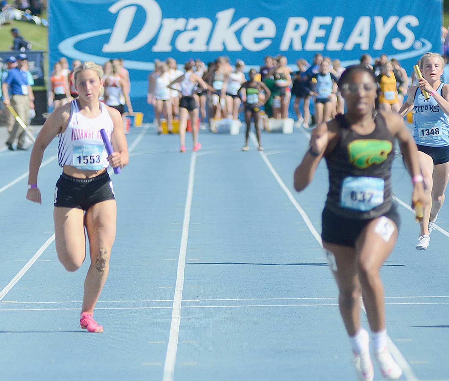 Nodaway Valley anchor runner Annika Nelson (left) nears the finish line of the 4x100 relay Saturday at the Drake Relays. The Wolverines were 67th in 51.81.