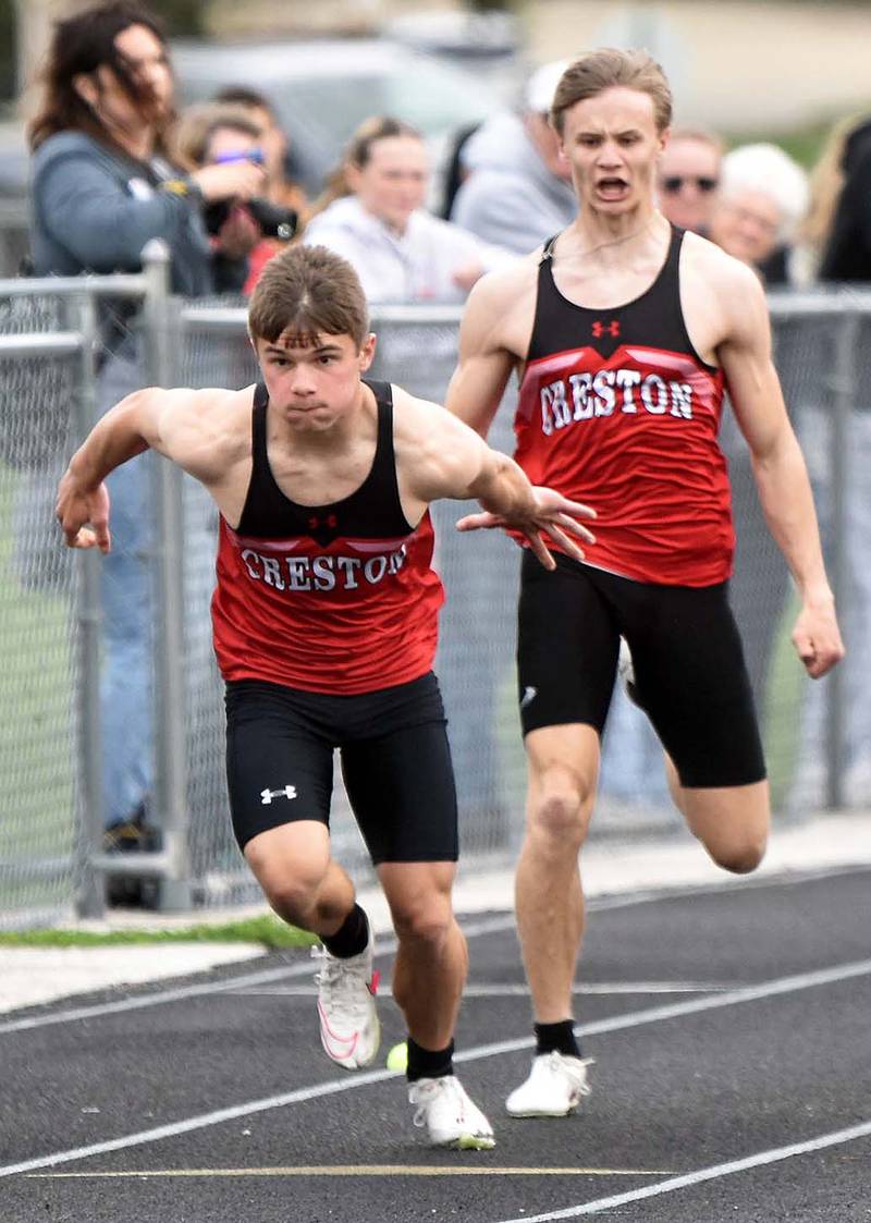Creston senior Tyler Riley (front) takes a handoff from Casen Dryden in a sprint relay. Riley earned Creston's 4x4 award for participation in four sports in four years, and received the Bernie Saggau award that honors student-athletes for "leadership, service, academic and athletic performance."