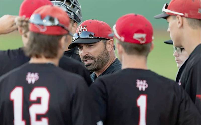 Casey Bryant meets with his Western Dubuque baseball team during a game. Bryant has coached the Bobcats to two state championships and seven state tournaments. He ranks 54th in Iowa all-time wins as a head coach with 647 in 26 seasons.