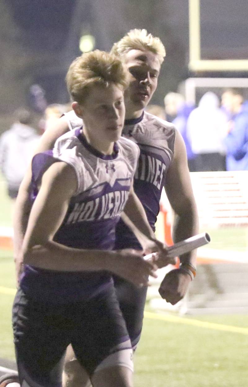 Nodaway Valley's Luke Kading gets the baton from Ashton Honnold during the Wolverines' 4x400-meter relay Thursday night in Earlham. The Wolverines placed ninth in the race in 4:01.48.