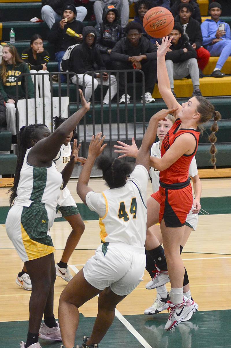 Creston guard Hollynn Rieck puts up a running shot against a convergence of Des Moines Hoover defenders in the lane. Rieck had eight points and a team-high five assists in the 63-12 victory.