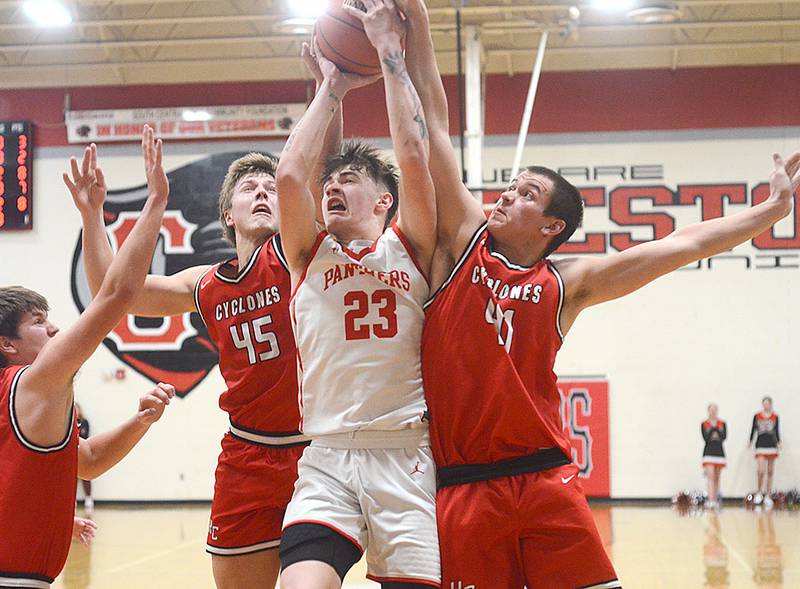 Creston's Jake Hoyt (23) draws a crowd of Harlan defenders on a drive to the basket Friday. Hoyt scored a team-high 22 points in the 60-58 loss.