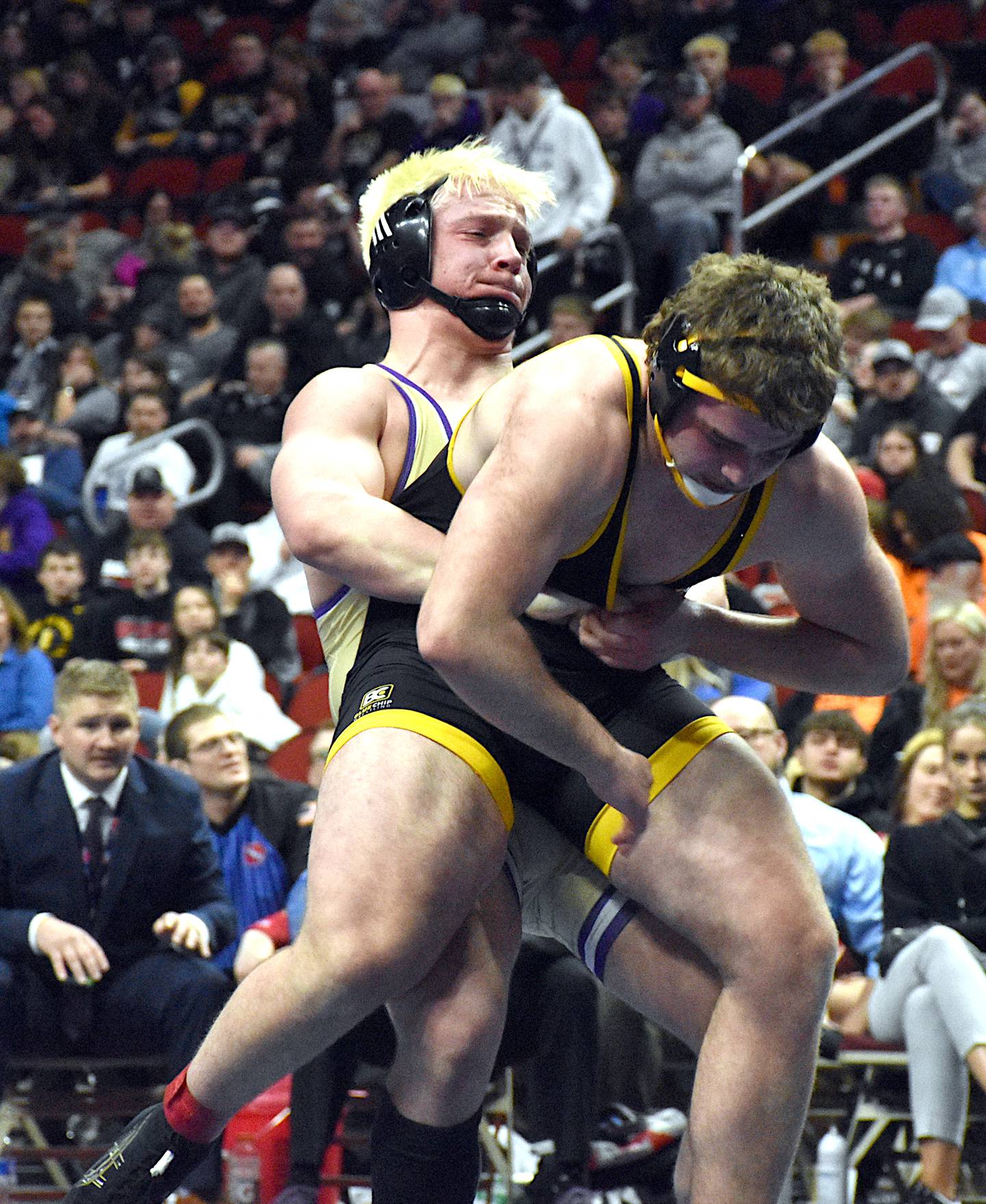 Wolverine sophomore Ashton Honnold hoists Maquoketa Valley's Brady Davis into the air for a mat return during the state title match in Class 1A at 215 pounds.