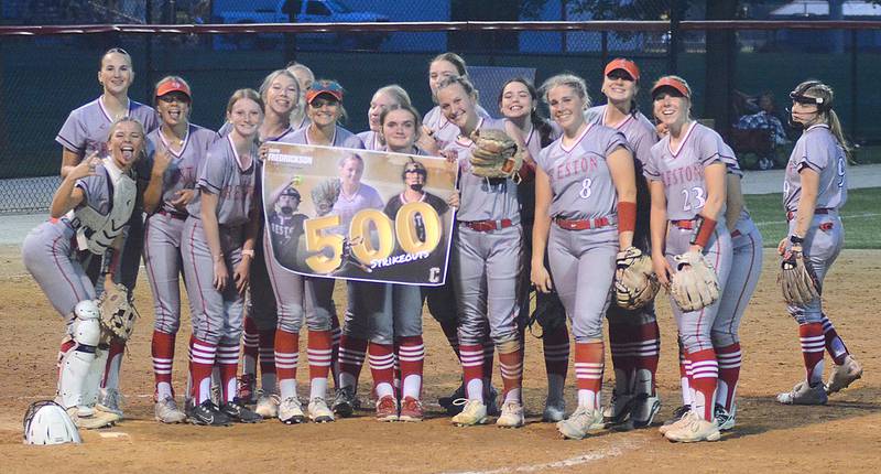 Teammates present Creston senior pitcher Taryn Fredrickson (at right edge of poster) with a poster commemorating her 500th career strikeout during Wednesday's 9-2 win over Atlantic.