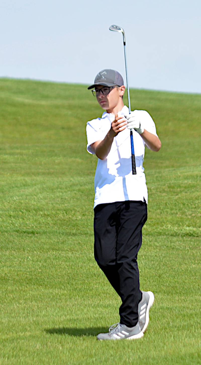 Wolverine boys golfer Sam Miller hits an approach shot during Pride of Iowa Conference golf action in Lenox.