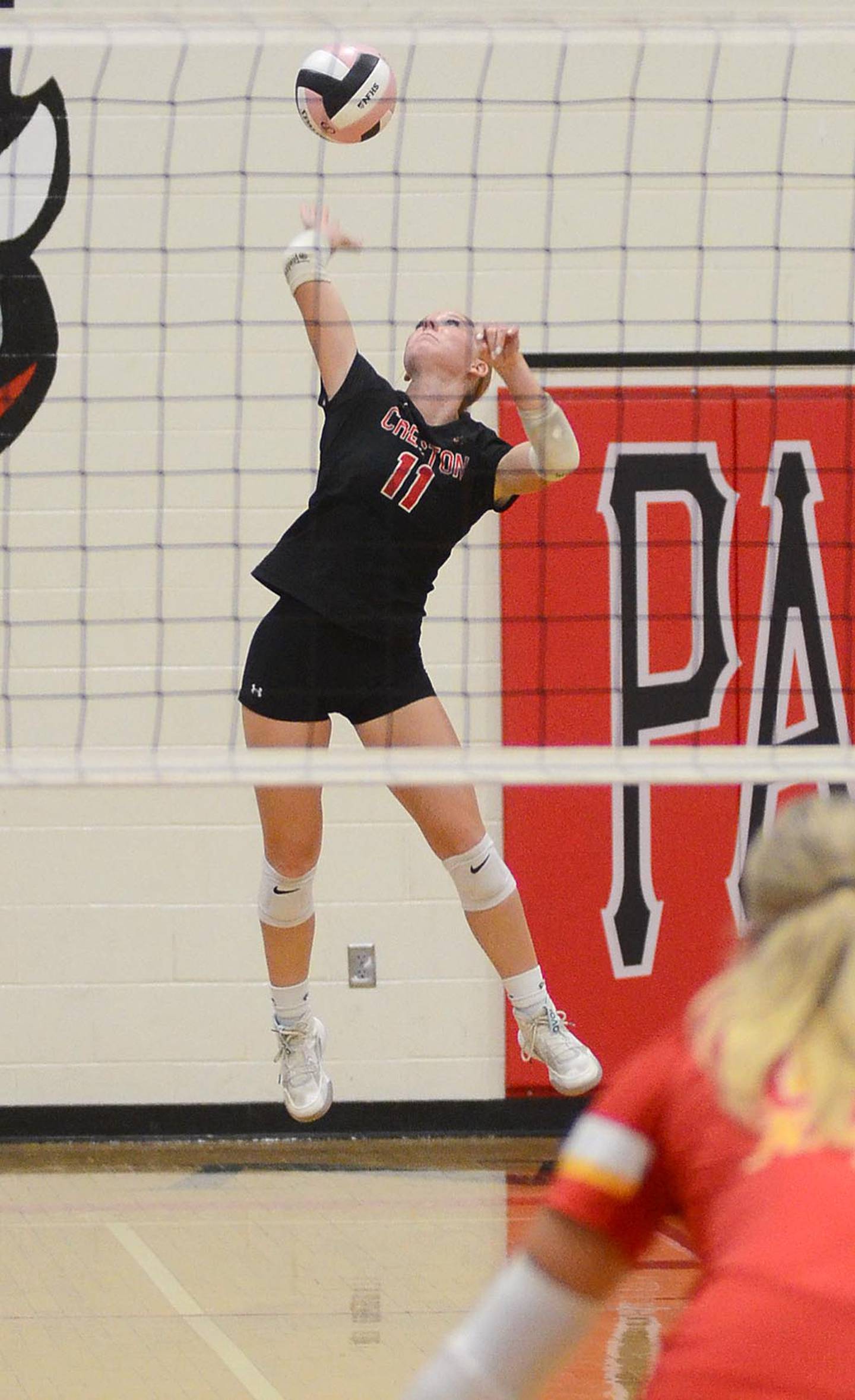 Avery Staver sends a serve to the Kuemper court. The Creston libero had a team high 14 digs and hit 11 of 12 serves.