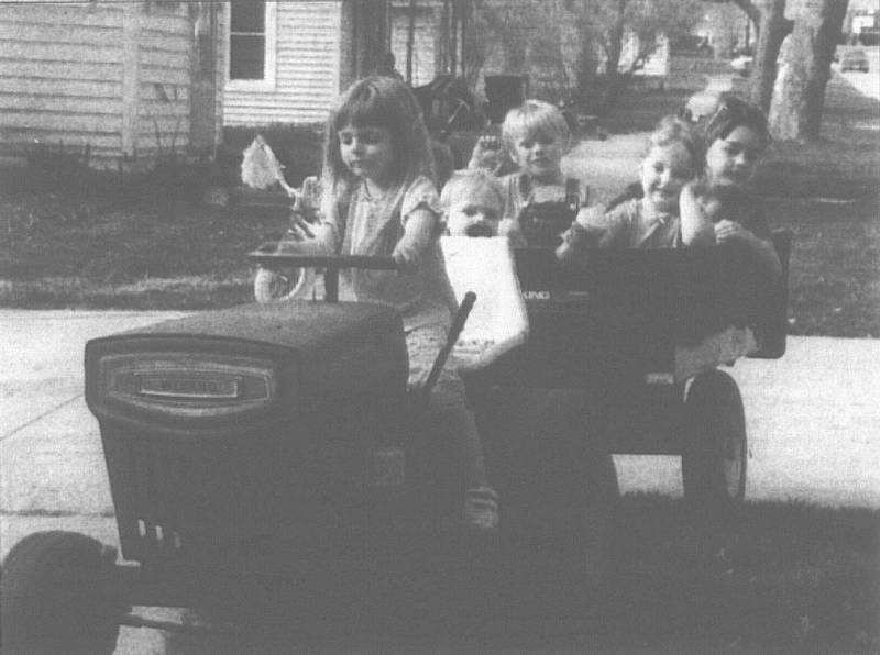 Kimberly Kendrick, 5, takes (clockwise from left) Trey Webb, 2, Isaac Hayes, 4, Rusty Anglin, 6, and Kassidy Kendrick, 3, for a spin around the family’s front yard Wednesday at the corner on South Pine Street. Jason Kendrick normally drives the kids around with the slow-moving utility tractor, but decided to give Kimberly a chance while he supervised.