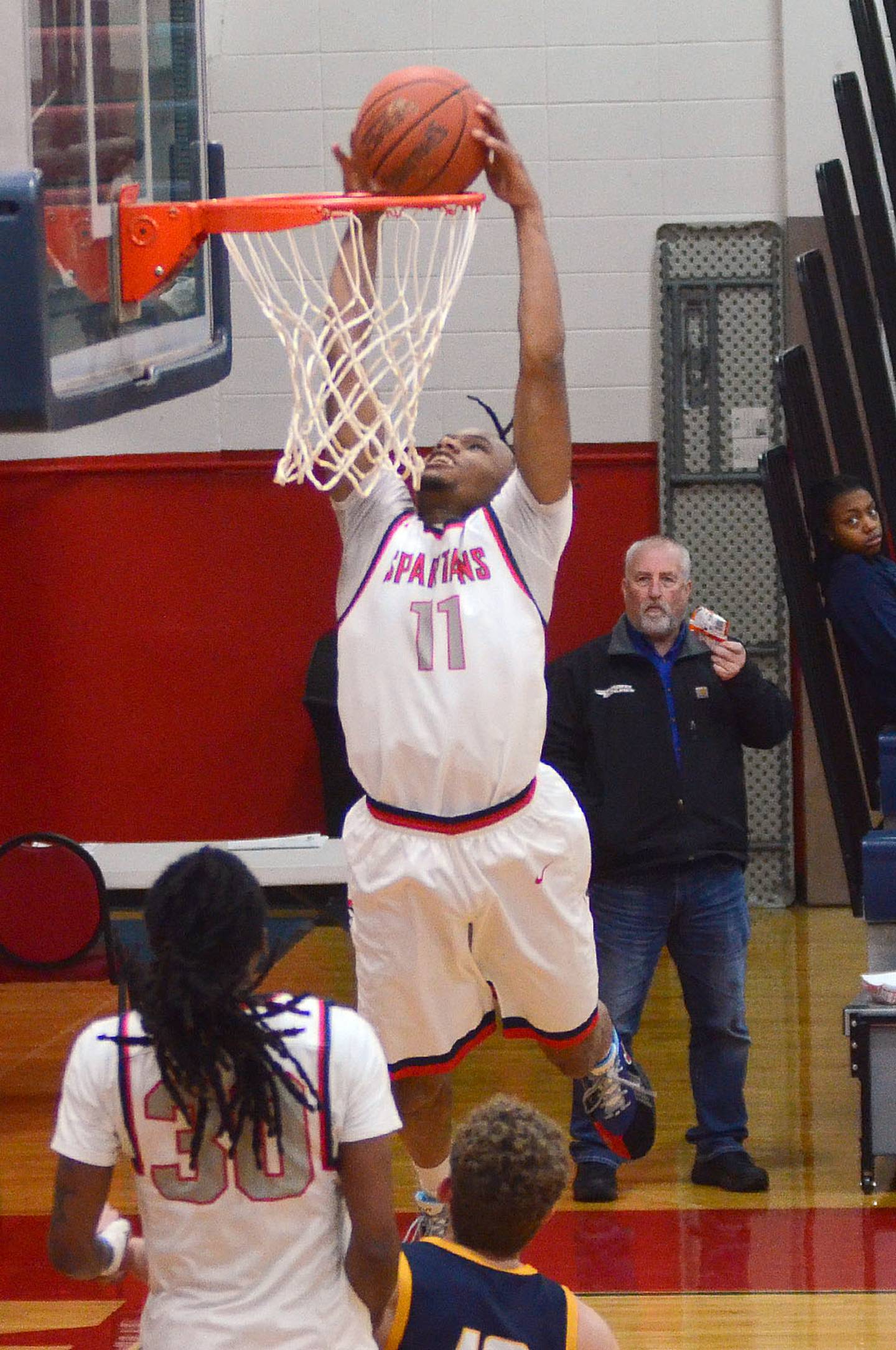 Micah Hines finishes a Spartan breakaway with a slam dunk against Iowa Lakes. Hines scored 17 points and had six steals in the 81-79 win.
