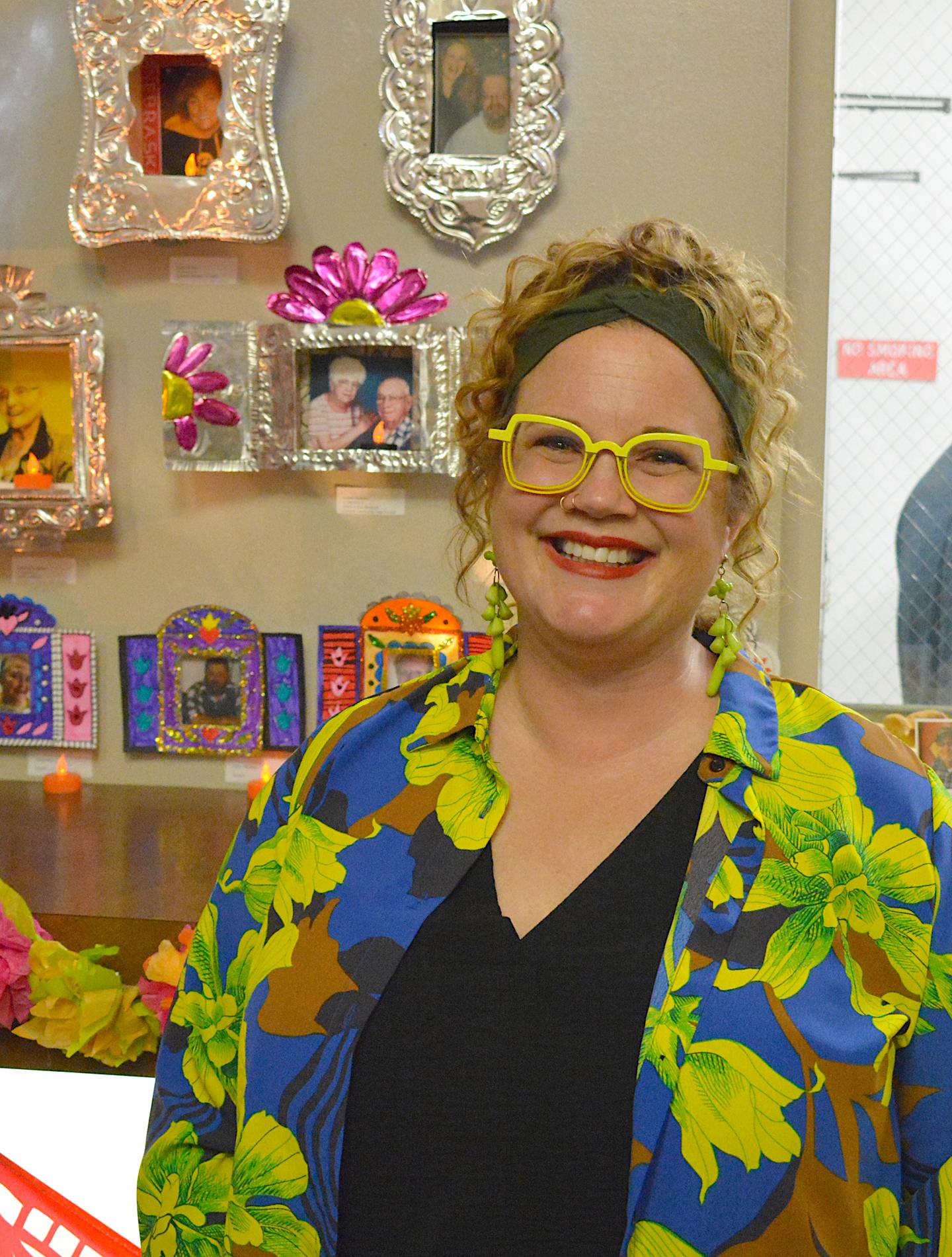 Bailey Fry-Schnormeier alongside a silver piece with flowers honoring her parents.