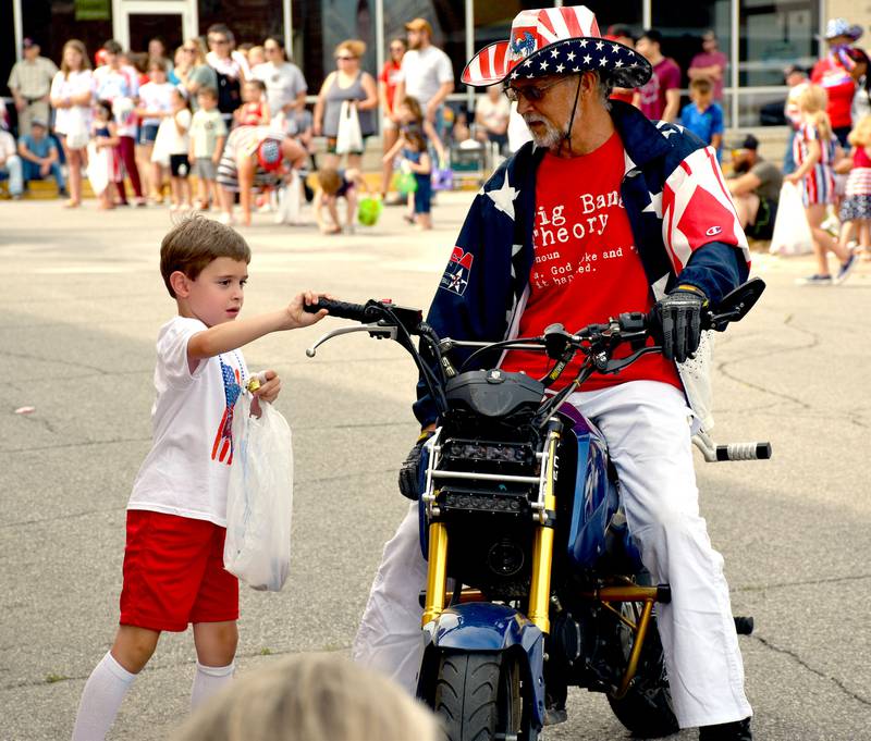 A young boy enjoys a portion of the 2023 Fourth of July parade.