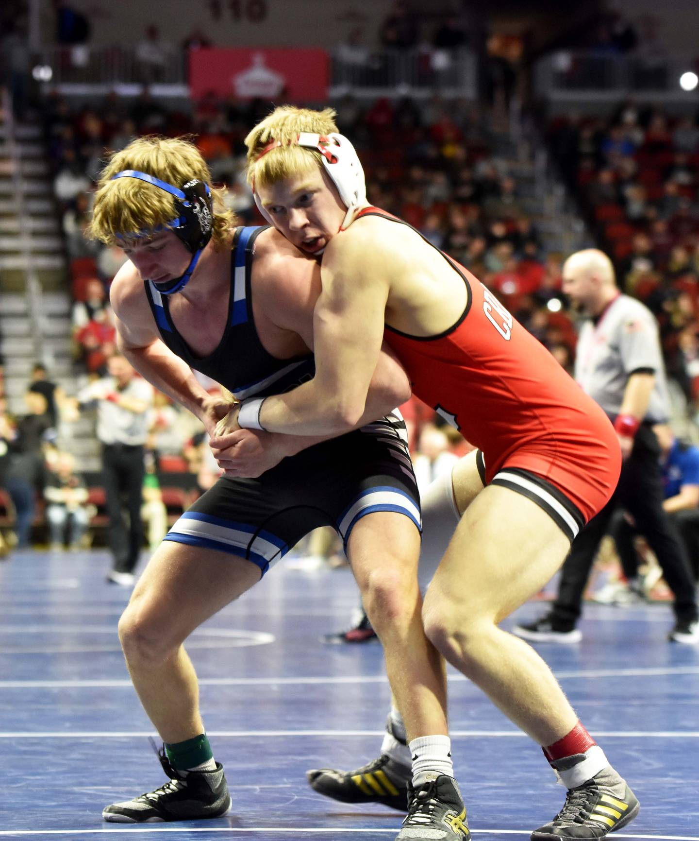 Senior Milo Staver (157) holds onto Miken Wheeler of Anamosa in the first round. Staver won the bout in a 9-4 decision.
