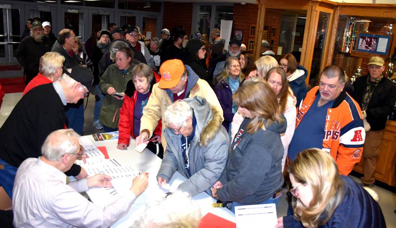 People register for the Republican caucus Monday at Creston High School. Despite the extreme cold temperatures and piles of snow from the previous week, county Republican officials were pleased with the attendance.